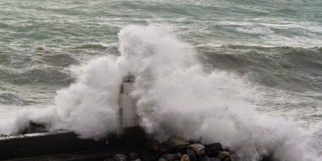 lighthouse hidden by a wave