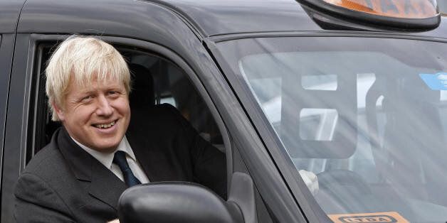 London Mayor Boris Johnson sits in a black cab at the London Taxi Driver Association (LTDA) in Westbourne Park, London, on May 14, 2008. Newly elected Conservative mayor Boris Johnson visited the association on Wednesday to launch a consultation on the abolition of half-yearly black cab inspections. The current mid-year inspections were launched in October 2007 and were accompanied by a GBP 36 increase in the annual licence fee to cover the costs. AFP PHOTO/Leon Neal (Photo credit should read Le