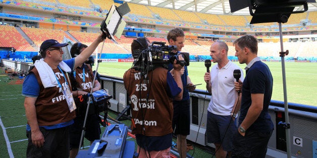 BBC television presenter Dan Walker (left) with pundits Danny Murphy (centre) and Phil Neville (right) working pitch side before kick-off