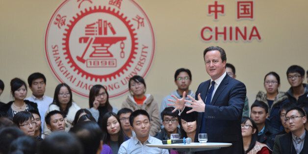 This picture taken on December 3, 2013 shows British Prime Minister David Cameron (R) delivering a speech at Shanghai Jiao Tong University in Shanghai. Britain should recognise it is not a big power but 'just an old European country apt for travel and study', Chinese state-run media snapped on December 3 as Cameron visited. CHINA OUT AFP PHOTO (Photo credit should read STR/AFP/Getty Images)
