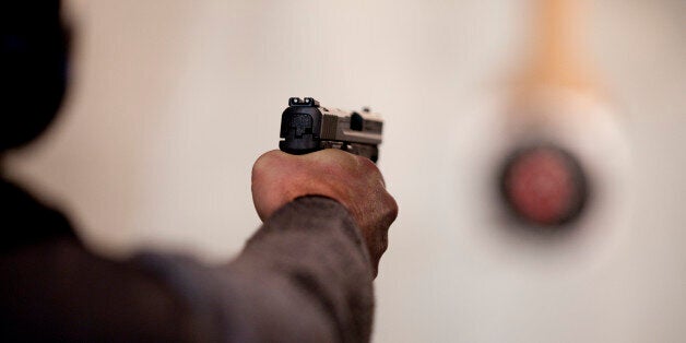 A student fires a semi-automatic handgun on the firing range at the end of a basic firearms safety class (file photo)