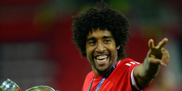 LONDON, ENGLAND - MAY 25: Dante of Bayern Muenchen holds the trophy after winning the UEFA Champions League final match against Borussia Dortmund at Wembley Stadium on May 25, 2013 in London, United Kingdom. (Photo by Shaun Botterill/Getty Images)