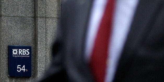 LONDON, ENGLAND - AUGUST 03: City workers pass a Royal Bank of Scotland (RBS) branch on St Marys Axe on August 3, 2012 in London, England. The bank has announced pre-tax losses of £1.5 billion after IT problems earlier in the year hit operations. (Photo by Matthew Lloyd/Getty Images)