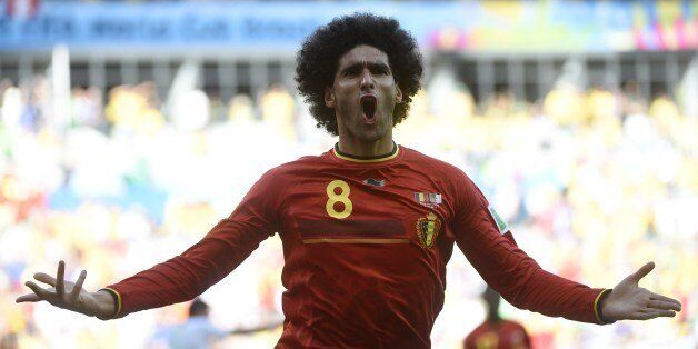 Belgium's midfielder Marouane Fellaini celebrates after scoring during a Group H football match between Belgium and Algeria at the Mineirao Stadium in Belo Horizonte during the 2014 FIFA World Cup on June 17, 2014. AFP PHOTO / MARTIN BUREAU (Photo credit should read MARTIN BUREAU/AFP/Getty Images)