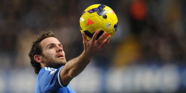Chelsea's Spanish midfielder Juan Mata holds the ball up during the English Premier League football match between Chelsea and Swansea City at Stamford Bridge in London on December 26, 2013. Chelsea won the game 1-0. AFP PHOTO / OLLY GREENWOODRESTRICTED TO EDITORIAL USE. No use with unauthorized audio, video, data, fixture lists, club/league logos or live services. Online in-match use limited to 45 images, no video emulation. No use in betting, games or single club/league/player publications. (Photo credit should read OLLY GREENWOOD/AFP/Getty Images)