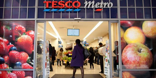 A customer walks into a Tesco Metro supermarket