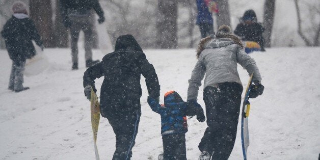 NEW YORK, UNITED STATES - JANUARY 21: People enjoy during the snow storm in New York City, United States, January 21, 2014. Winter storm Hercules has brought heavy snowfall and freezing temperatures to especially southeastern United States. (Photo by Cem Ozdel/Anadolu Agency/Getty Images)