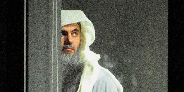 Radical cleric Abu Qatada (L) prepares to board a plane at RAF Northolt which will take him to Jordan, after he was deported from the UK to face terrorism charges in his home country, on July 7, 2013 in London, England. (Photo by Sgt Ralph Merry/MoD via Getty Images)