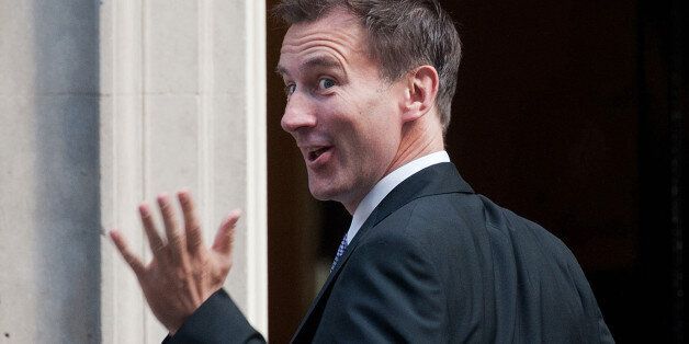 British politician Jeremy Hunt gestures towards the media as he arrives at no 10 Downing Street in central London on September 4, 2012 to meet with Britain's Prime Minister David Cameron and receive his new appointment as health secretary in Cameron's first cabinet reshuffle. Cameron reshuffled his ailing coalition government on September 4, but unpopular finance minister George Osborne was expected to keep his job. Jeremy Hunt was moved from culture secretary to be the new health secretary with