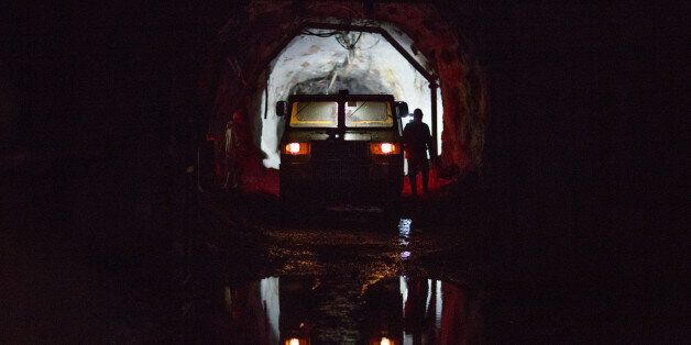 A mine transport vehicle stands ready to collect miners after they finish their shifts in an underground tunnel at the OAO Alrosa diamond mine in Udachny, Sakha Republic, Russia, on Thursday, Dec. 12, 2013. Russia plans to maintain control of Mirny-based Alrosa, which produces a quarter of the world's diamonds by value and more rough diamonds than De Beers by carat. Photographer: Andrey Rudakov/Bloomberg via Getty Images