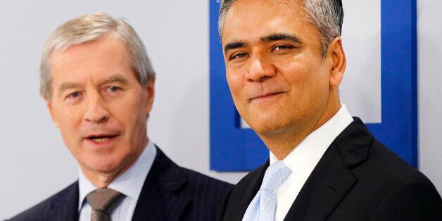 CEOs of Deutsche Bank Anshu Jain, right, and Juergen Fitschen stand together prior to the annual press conference in Frankfurt, Germany, Wednesday, Jan. 29, 2014. Germany's biggest bank had a surprise loss of 965 million euros (US dollar 1.32 billion) in the fourth quarter, as earnings were burdened by 528 million in costs for court settlements and investigations into alleged past misconduct in the fourth quarter. (AP Photo/Michael Probst)