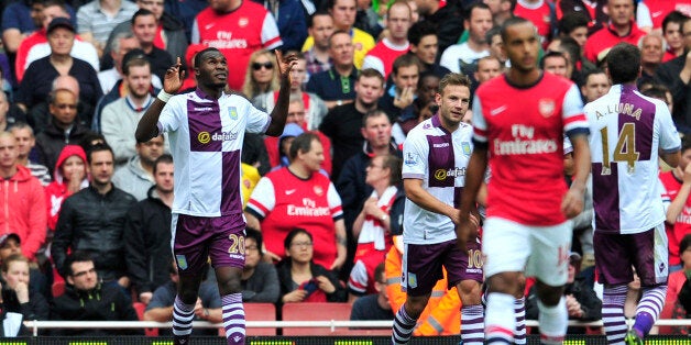 Aston Villa's Belgian striker Christian Benteke (L) celebrates scoring his team's first goal to equalise the score line during the English Premier League football match between Arsenal and Aston Villa at the Emirates stadium in North London on August 17, 2013. AFP PHOTO/GLYN KIRK == RESTRICTED TO EDITORIAL USE. NO USE WITH UNAUTHORIZED AUDIO, VIDEO, DATA, FIXTURE LISTS, CLUB/LEAGUE LOGOS OR LIVE SERVICES. ONLINE IN-MATCH USE LIMITED TO 45 IMAGES, NO VIDEO EMULATION. NO USE IN BETTING, GAMES OR