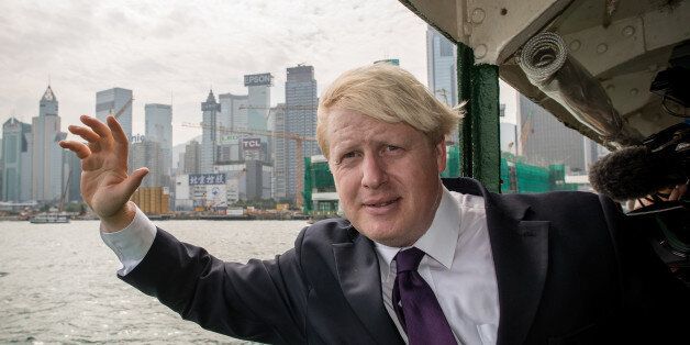 London Mayor Boris Johnson waves as he crosses Victoria Harbour on a Star Ferry during his visit in Hong Kong on October 18, 2013. Johnson is in the former British colony on the last leg of a trade mission to China from 13-18 October 2013 aimed at promoting London as a major investment destination. AFP PHOTO / Philippe Lopez (Photo credit should read PHILIPPE LOPEZ/AFP/Getty Images)