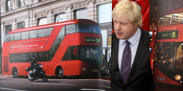 LONDON, ENGLAND - MAY 17: Mayor of London Boris Johnson poses with artists impressions of the design for London's new Routemaster bus on May 17, 2010 in London, England. The new double-decker buses, which will feature a rear open platform enabling people to 'hop-on hop-off', are claimed to be 40% more fuel efficient than current London buses and are due to go into service in 2011. (Photo by Oli Scarff/Getty Images)