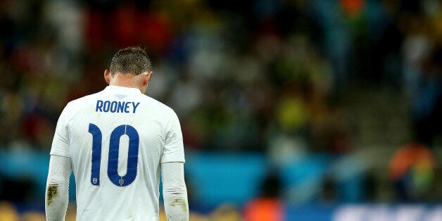 SAO PAULO, BRAZIL - JUNE 19: A dejected Wayne Rooney of England walks on after losing to Uruguay 2-1 during the 2014 FIFA World Cup Brazil Group D match between Uruguay and England at Arena de Sao Paulo on June 19, 2014 in Sao Paulo, Brazil. (Photo by Richard Heathcote/Getty Images)