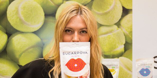 PARIS, FRANCE - MAY 22: Tennis player Maria Sharapova poses with a Sugarpova candy packet during the French launch of her Sugarpova candy collection at Colette on May 22, 2013 in Paris, France. (Photo by Richard Bord/Getty Images for Sugarpova)