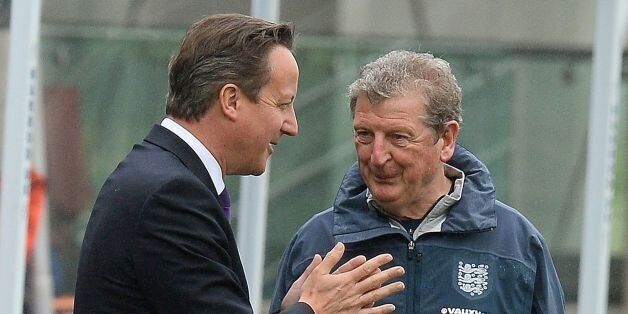 Prime Minister David Cameron chats with England manager Roy Hodgson during a training session at England's football training headquarters St Georges Park, in Burton-Upon-Trent.