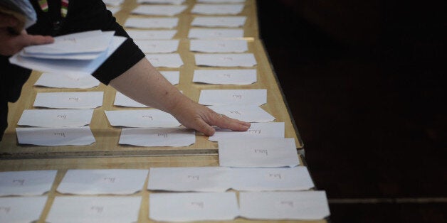 BATH, UNITED KINGDOM - AUGUST 19: A member of the teaching staff prepares the A-level results for collection at Hayesfield Girls' School on August 19, 2010 in Bath, England. Thousands of students are anxiously finding out their results today as places at university become a premium with a record number of applications. (Photo by Matt Cardy/Getty Images)