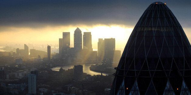 Embargoed to 0001 Monday January 20 File photo dated 25/02/10 of the 'Gherkin' and Canary Wharf at sunrise in the City of London as economic recovery is starting to feed through to the financial services sector, with rising profits and jobs, a new study has shown.