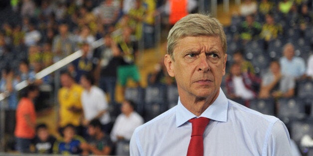 Arsenal's head coach Arsene Wenger looks on ahead of the UEFA Champions League Play Off first leg match between Fenerbahce and Arsenal at Sukru Saracoglu Stadium in Istanbul on August 21, 2013. AFP PHOTO/OZAN KOSE (Photo credit should read OZAN KOSE/AFP/Getty Images)