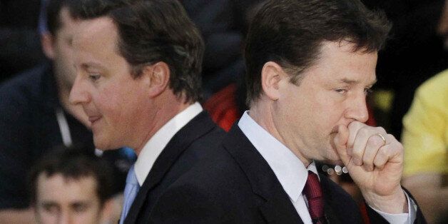 File photo dated 12/5/2011 of Prime Minister David Cameron walks past Deputy Prime Minister Nick Clegg. The pair must draw up rules to stop public splits on government policy after a spate of clashes, peers have warned.