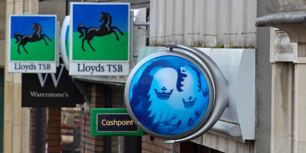 Signs sit outside branches of a Lloyds TSB bank, part of the Lloyds Banking Group Plc, a Barclays Plc bank, a NatWest bank, part of the Royal Bank of Scotland Group Plc (RBS), and a HSBC Holdings Plc bank in Staines, U.K., on Tuesday, Dec. 18, 2012. The European Union is leading a probe into Libor rigging that could see global banks fined as much as 10 percent of their annual revenue. Photographer: Chris Ratcliffe/Bloomberg via Getty Images