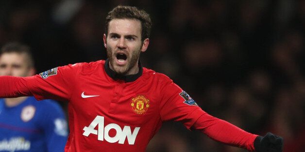 MANCHESTER, ENGLAND - JANUARY 28: Juan Mata of Manchester United celebrates Robin van Persie scoring their first goal during the Barclays Premier League match between Manchester United and Cardiff City at Old Trafford on January 28, 2014 in Manchester, England. (Photo by John Peters/Man Utd via Getty Images)