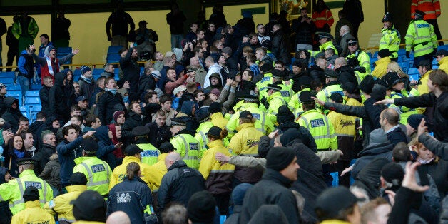 Police and stewards separate opposition supporters during the English Premier League football match between Manchester City and Manchester United at The Etihad stadium in Manchester, north-west England on December 9, 2012. AFP PHOTO/PAUL ELLIS RESTRICTED TO EDITORIAL USE. No use with unauthorized audio, video, data, fixture lists, club/league logos or ?live? services. Online in-match use limited to 45 images, no video emulation. No use in betting, games or single club/league/player publications