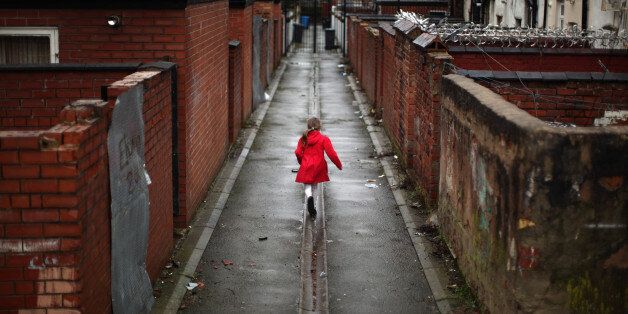 A young girl spends the half term school holiday playing in an an alleyway in the Gorton area of Manchester
