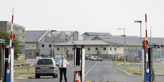 A security guard stands at the gates of the The Yarl's Wood Immigration Center