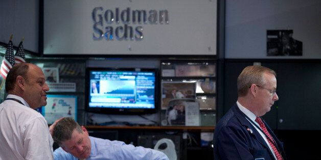 Traders work at the Goldman Sachs Group Inc. booth on the floor of the New York Stock Exchange (NYSE) in New York, U.S., on Friday, Jan. 24, 2014. U.S. stocks fell, pushing the Dow Jones Industrial Average to the biggest weekly decline since June 2012, as equities slumped worldwide amid a selloff in emerging-market currencies. Photographer: Jin Lee/Bloomberg via Getty Images