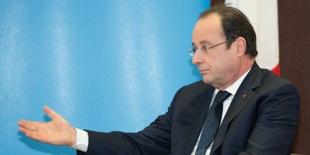 French President Francois Hollande gestures as he speaks during a meeting with British Prime Minister David Cameron during a one day summit at RAF Brize Norton.