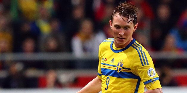 STOCKHOLM, SWEDEN - NOVEMBER 19: Kim Kaellstroem of Sweden runs with the ball during the FIFA 2014 World Cup Qualifier Play-off Second Leg match between Sweden and Portugal at Friends Arena on November 19, 2013 in Stockholm, Sweden. (Photo by Martin Rose/Getty Images,)