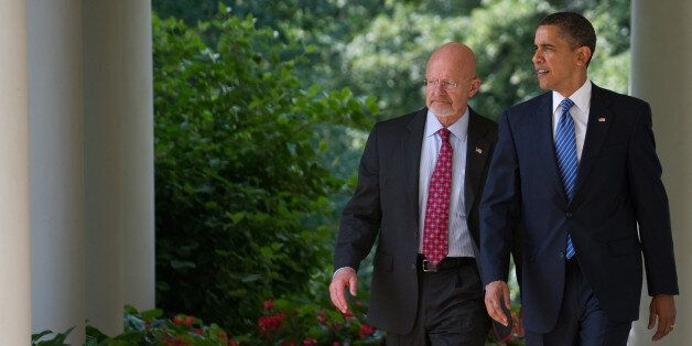 US President Barack Obama walks back down the West Wing Colonnade alongside retired General James Clapper, Obama's nominee for director of national intelligence, before making a statement in the Rose Garden of the White House in Washington, DC, June 5, 2010. AFP PHOTO / Saul LOEB (Photo credit should read SAUL LOEB/AFP/Getty Images)