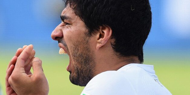 NATAL, BRAZIL - JUNE 24: Luis Suarez of Uruguay reacts after a clash during the 2014 FIFA World Cup Brazil Group D match between Italy and Uruguay at Estadio das Dunas on June 24, 2014 in Natal, Brazil. (Photo by Matthias Hangst/Getty Images)