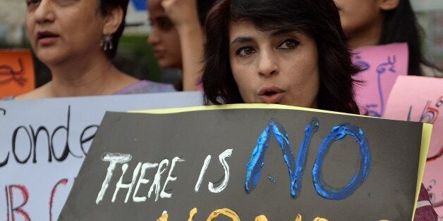 Pakistani human rights activists hold placards during a protest in Islamabad on May 29, 2014 against the killing of a pregnant woman Farzana Parveen was beaten to death with bricks by members of her own family for marrying a man of her own choice in Lahore. Pakistan's prime minister demanded 'immediate action' over the brutal murder of a pregnant woman who was bludgeoned to death with bricks outside a courthouse while police stood by. Farzana Parveen was attacked on May 27 outside the High Court