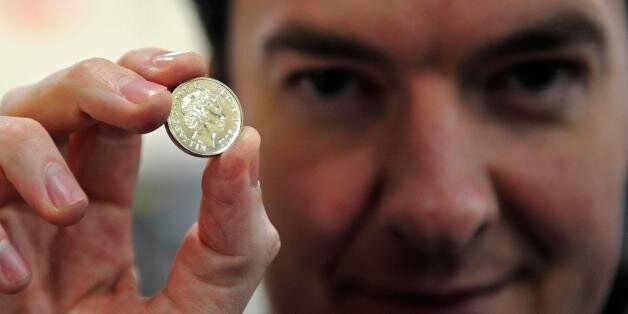 CARDIFF, WALES - MARCH 5: Chancellor of the Exchequer George Osborne, poses with a newly minted one pound coin during a visit to the Royal Mint on March 5, 2011 in Cardiff, United Kingdom. The Conservative Party is in Wales for it's annual spring forum. (Photo by Toby Melville - WPA Pool/GEtty Images)