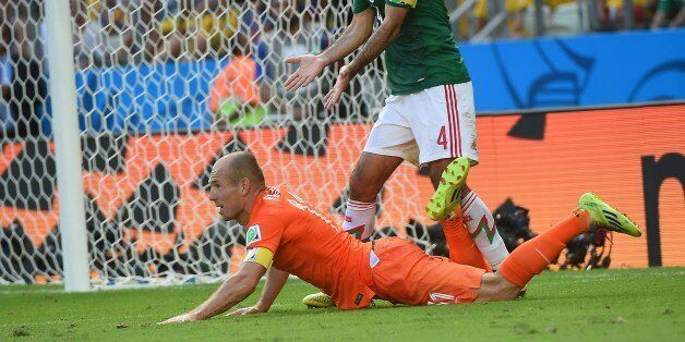 Mexico's defender and captain Rafael Marquez (TOP) reacts after the awarding of a penalty after a tackle on Netherlands' forward Arjen Robben (R) during a Round of 16 football match between Netherlands and Mexico at Castelao Stadium in Fortaleza during the 2014 FIFA World Cup on June 29, 2014. AFP PHOTO / EMMANUEL DUNAND (Photo credit should read EMMANUEL DUNAND/AFP/Getty Images)