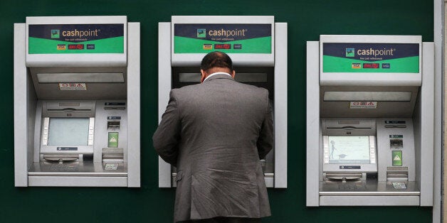 LONDON, ENGLAND - SEPTEMBER 17: A customer uses a cash machine at Lloyd's Bank branch on September 17, 2013 in London, England. The government has sold 6% of it's share in the Lloyds Banking Group. The tax payer rescued the bank with an injection of £20.5 billion during the 2008 financial crisis. (Photo by Peter Macdiarmid/Getty Images)