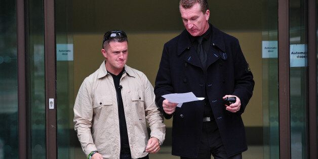 Stephen Yaxley-Lennon (L), also known as Tommy Robinson, the co-founder, spokesman and leader of the English Defence League (EDL) and EDL Deputy Leader Kevin Carroll (R) leave after attending Westminster Magistrates Court in central London, on September 11, 2013. Both are accused of obstructing police by trying to defy a ban on marching to the scene of Fusilier Lee Rigby's murder via the East London Mosque on June 29