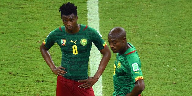 MANAUS, BRAZIL - JUNE 18: Benjamin Moukandjo and Pierre Webo of Cameroon wait to kick off after a goal during the 2014 FIFA World Cup Brazil Group A match between Cameroon and Croatia at Arena Amazonia on June 18, 2014 in Manaus, Brazil. (Photo by Stu Forster/Getty Images)