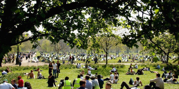 LONDON - APRIL 17: People enjoy the sun and high temperature at Green Park April 17, 2003 in London. Temperatures on April 16 matched those of Cyprus and beat those of Greece, Italy and coastal Spain, where many Britons are heading over the Easter break. Despite the heat, 1.8 million people are expected to leave Britain, with a million passengers departing by air. (Photo by Scott Barbour/Getty Images)