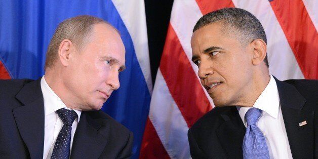 US President Barack Obama (R) listens to Russian President Vladimir Putin after their bilateral meeting in Los Cabos, Mexico on June 18, 2012 on the sidelines of the G20 summit. Obama and President Vladimir Putin met Monday, for the first time since the Russian leader's return to the presidency, for talks overshadowed by a row over Syria. The closely watched meeting opened half-an-hour late on the sidelines of the G20 summit of developed and developing nations, as the US leader sought to preserv