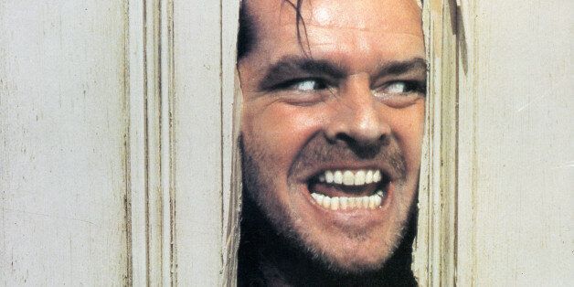 Jack Nicholson peering through axed in door in lobby card for the film 'The Shining', 1980. (Photo by Warner Brothers/Getty Images)