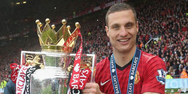 MANCHESTER, ENGLAND - MAY 12: Nemanja Vidic of Manchester United celebrates with the Premier League trophy after the Barclays Premier League match between Manchester United and Swansea at Old Trafford on May 12, 2013 in Manchester, England. (Photo by John Peters/Man Utd via Getty Images)