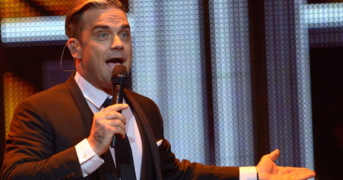 Robbie Williams Breaks Fan's Arm After Falling Off Stage During 'Swings ...