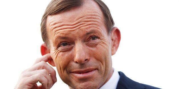 Tony Abbott, Australia's opposition leader, adjusts his earpiece before a television interview outside the polling station at the Freshwater Surf Life Saving Club in Sydney, Australia, on Saturday, Sept. 7, 2013. Australian voters are heading to eject the Labor party after six years in power, with opinion polls showing they will put Abbott's Liberal-National coalition in charge of the $1.5 trillion economy. Photographer: Brendon Thorne/Bloomberg via Getty Images