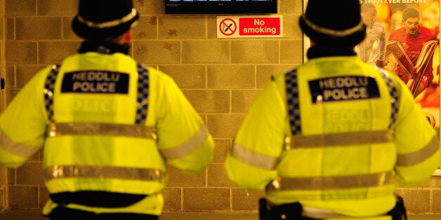 SWANSEA, WALES - FEBRUARY 08: Policemen catch the 6 nations match between Ireland and Wales before the Barclays Premier League match between Swansea City and Cardiff City at Liberty Stadium on February 8, 2014 in Swansea, Wales. (Photo by Stu Forster/Getty Images)