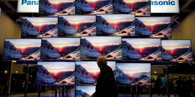 A fairgoer walks past a display of Panasonic Smart Viera 4K ultra HD Televisions at the Panasonic stand at the 53rd edition of the IFA (Internationale Funkausstellung) electronics trade fair in Berlin on September 4, 2013. IFA, Europe's largest consumer electronics and home appliances fair, opens from 6 to 11 September 2013. AFP PHOTO / JOHN MACDOUGALL (Photo credit should read JOHN MACDOUGALL/AFP/Getty Images)