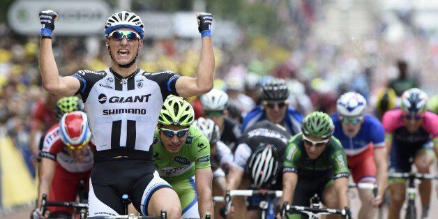 Germany's Marcel Kittel celebrates as he crosses the finish line at the end of the 155 km third stage of the 101st edition of the Tour de France cycling race on July 7, 2014 between Cambridge and London, southwestern England. AFP PHOTO / ERIC FEFERBERG (Photo credit should read ERIC FEFERBERG/AFP/Getty Images)